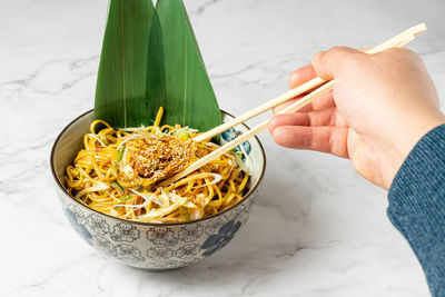 Cropped hand of person holding food