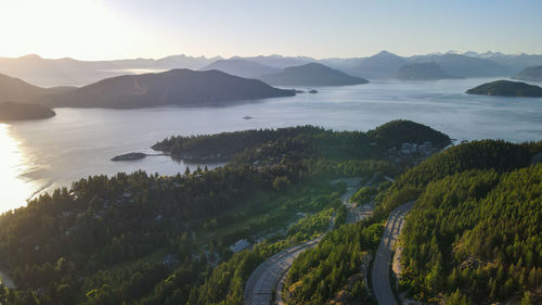 Scenic view of sea and mountains against sky