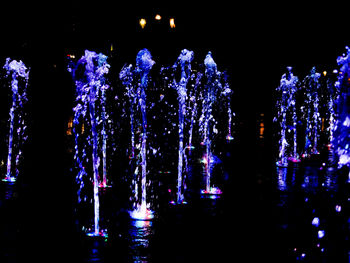 Illuminated lights against sky at night