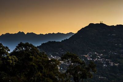 Scenic view of silhouette mountains against sky at sunset