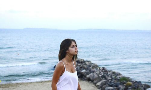 Rear view of woman standing on beach