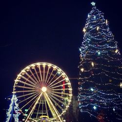 Low angle view of ferris wheel at night