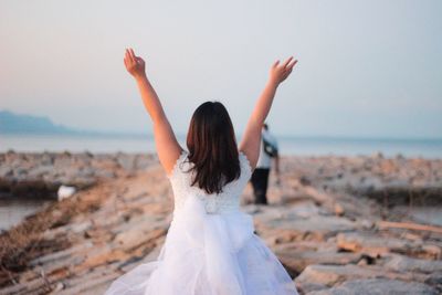 Rear view of woman walking on beach