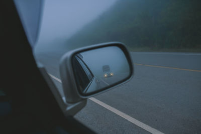 Reflection of car on side-view mirror