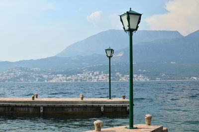 Two green lanterns on sea docks in the bay of kotor, in montenegro
