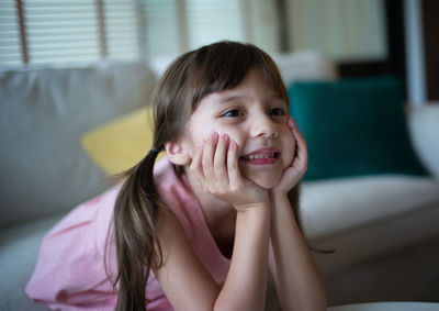 Portrait of a smiling girl sitting at home