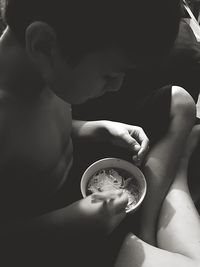 High angle view of boy having food at home