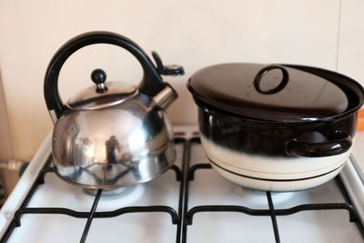 Kettle and container on stove at home