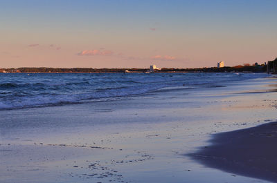 Scenic view of beach against sky during sunset