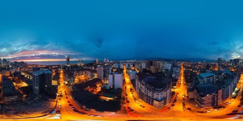 High angle view of illuminated cityscape against sky at night