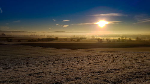 Scenic view of field against sky during sunset