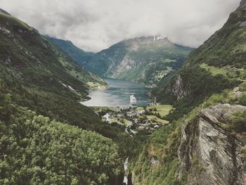 Scenic view of river and mountains against sky