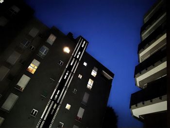 Low angle view of illuminated building against sky at dusk