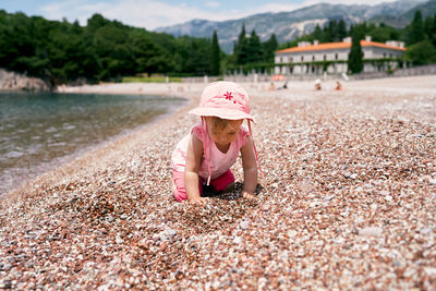 Full length of cute girl in pink hat