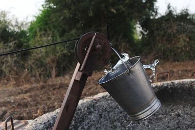 Close-up of metal container on field