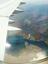 Cropped image of airplane flying over landscape