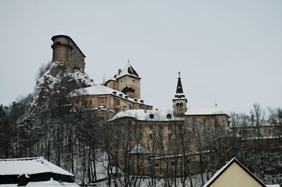 Low angle view of building against clear sky during winter