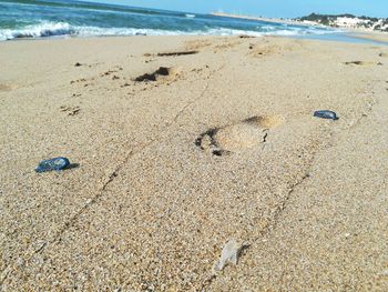 High angle view of footprints on sand at beach