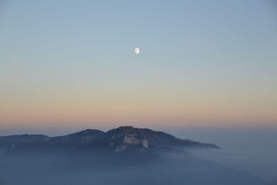 Scenic view of mountains against sky at sunset