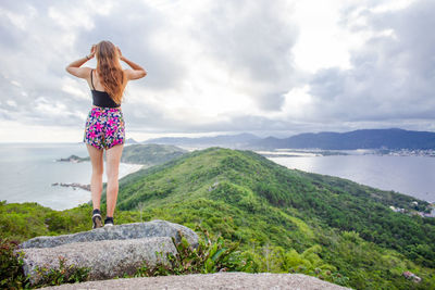Rear view of woman standing on mountain