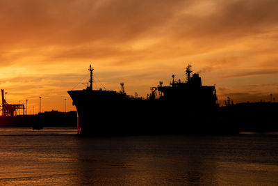 Profile of a tanker ship at sunset
