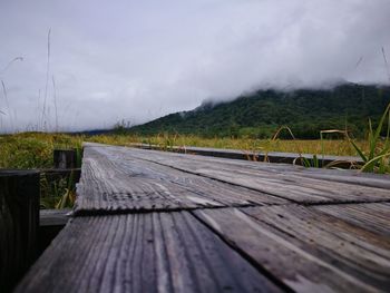 Surface level of boardwalk against sky