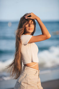 Young woman standing at beach