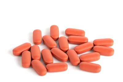 Close-up of pills over white background