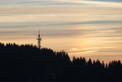 Silhouette trees against sky during sunset