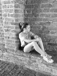 Girl sitting on wall