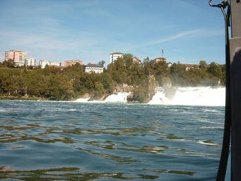 River in town against sky