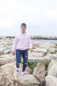 Portrait of young man standing on rock