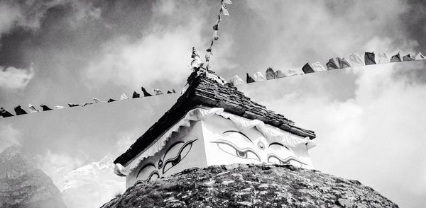 Low angle view of temple against cloudy sky