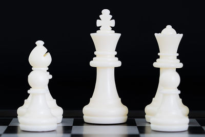 Close-up of chess pieces against black background