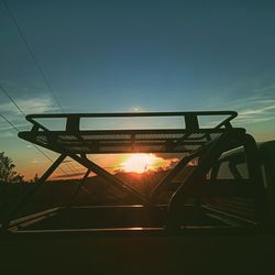 Low angle view of silhouette bridge against sky during sunset