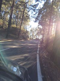 Road amidst trees against sky