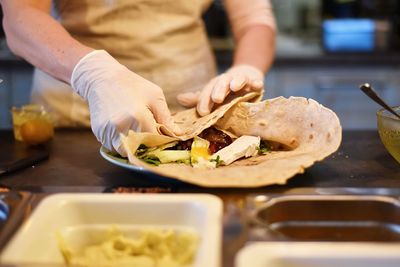 Midsection of person preparing food at table