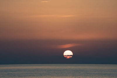 Scenic view of sea against orange sky