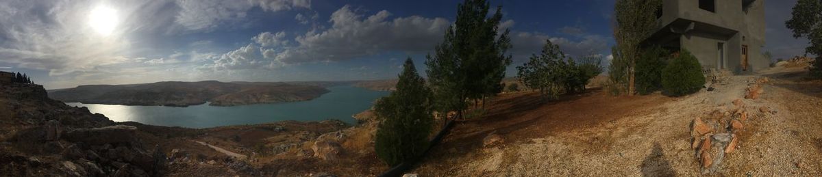 Panoramic view of sea and mountains against sky