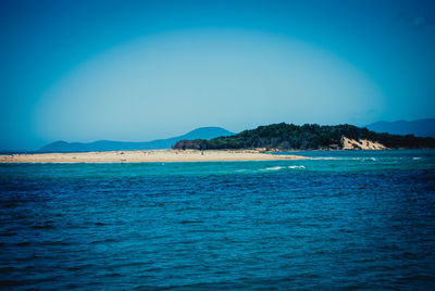 Scenic view of sea against clear blue sky