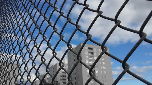 Low angle view of chainlink fence against clear sky