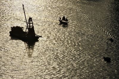 High angle view of silhouette boat in sea