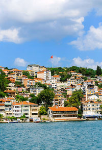 View of town by sea against sky