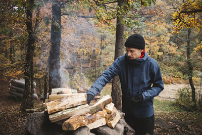 Man making campfire in forest