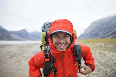 Portrait of happy backpacker in remote location.