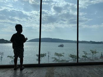 A boy looking at the sea view