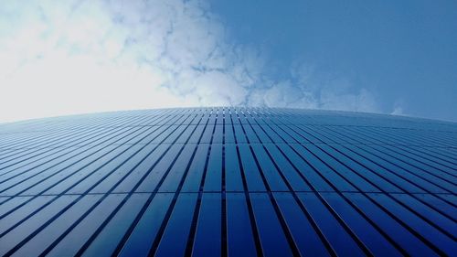 Low angle view of modern building against blue sky