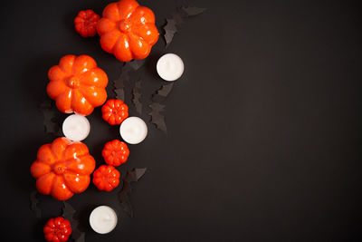 High angle view of orange berries against black background