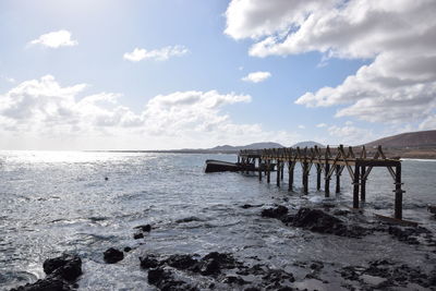 Pier over sea against sky