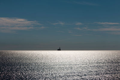 Sailboat sailing on sea against sky